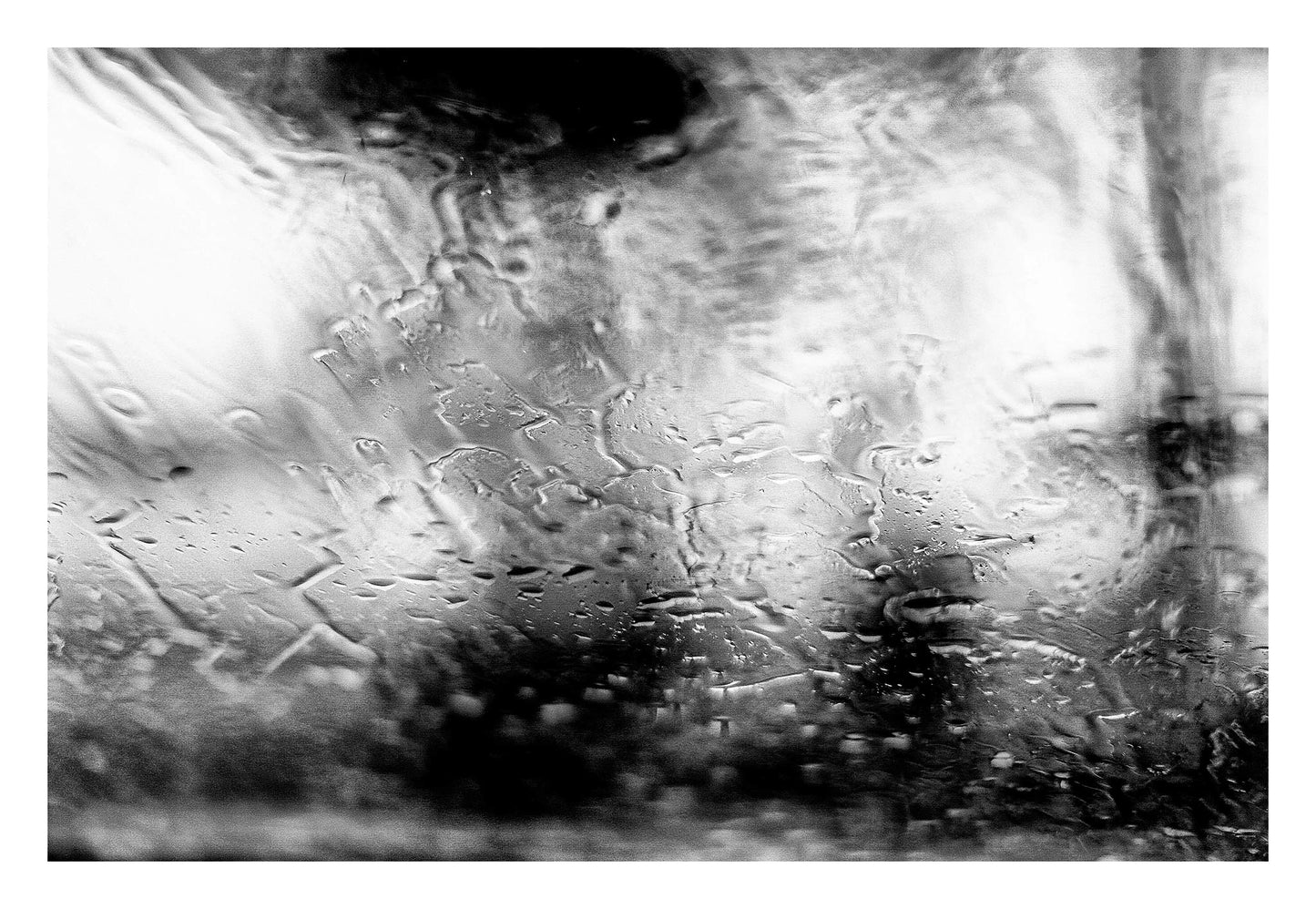 Coastal Noir 7185 - 104x74cm, Black and white abstract coastal photograph with people with umbrellas blurred behind rain-speckled glass, minimalist fine art print.