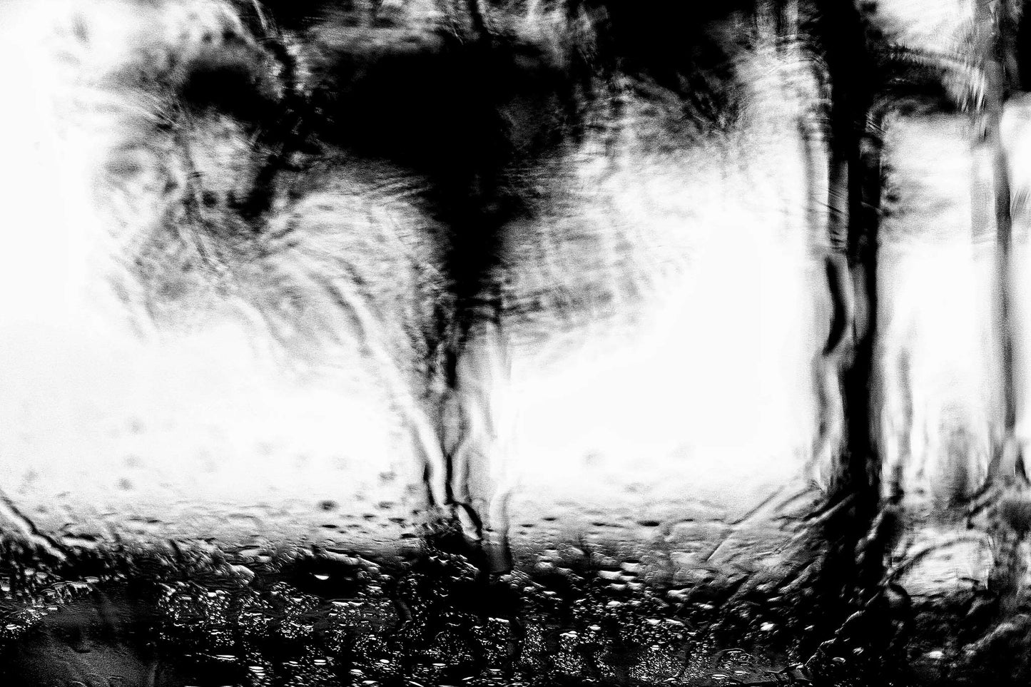 Coastal Noir 7221 - 90x60cm, black and white coastal scene with blurred jetty and trees through rain-speckled glass, abstract minimalist print.