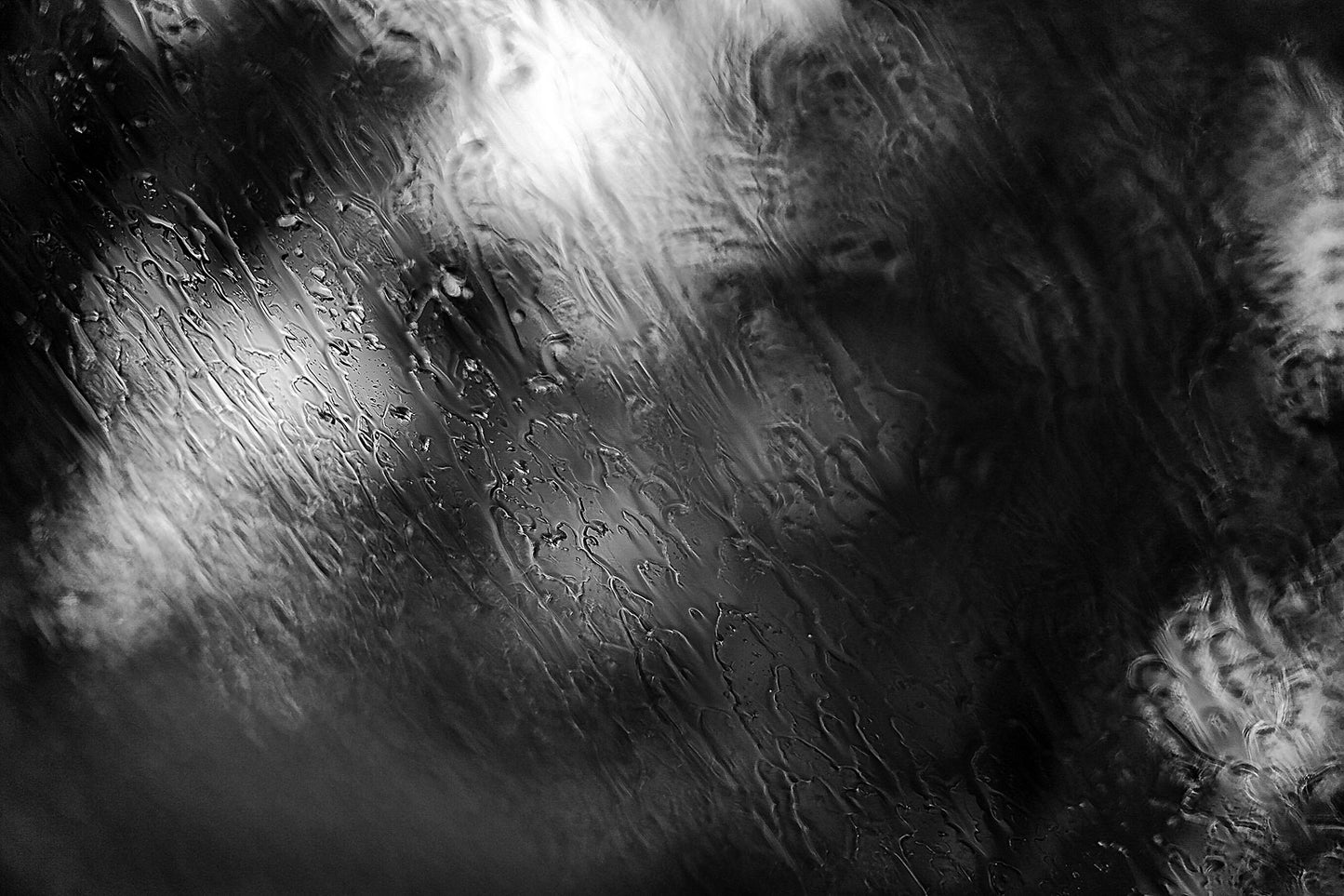 Coastal Noir 7982 - 90x60cm, abstract black and white coastal image with layered rain textures over blurred trees and shoreline.