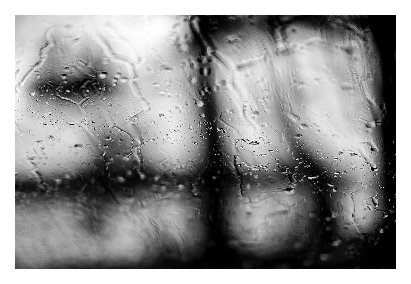 Coastal Noir 8007 - 104x74cm, black and white coastal scene with rain on glass and abstracted tree forms in soft focus.