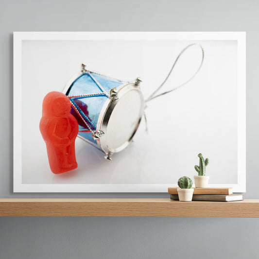 Beat of a Different Drum 2948 - Room View, red jelly figure leaning on a miniature blue drum ornament, fine art photographic print by Raymond Mather, ART1.
