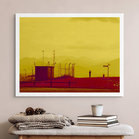 Vivid Country - Coffs Harbour The Selfie 1932v36a - Room View, a lone figure takes a selfie at a mountaintop lookout, silhouetted against layered hills and framed by golden tones and utilitarian structures in this modern landscape portrait.