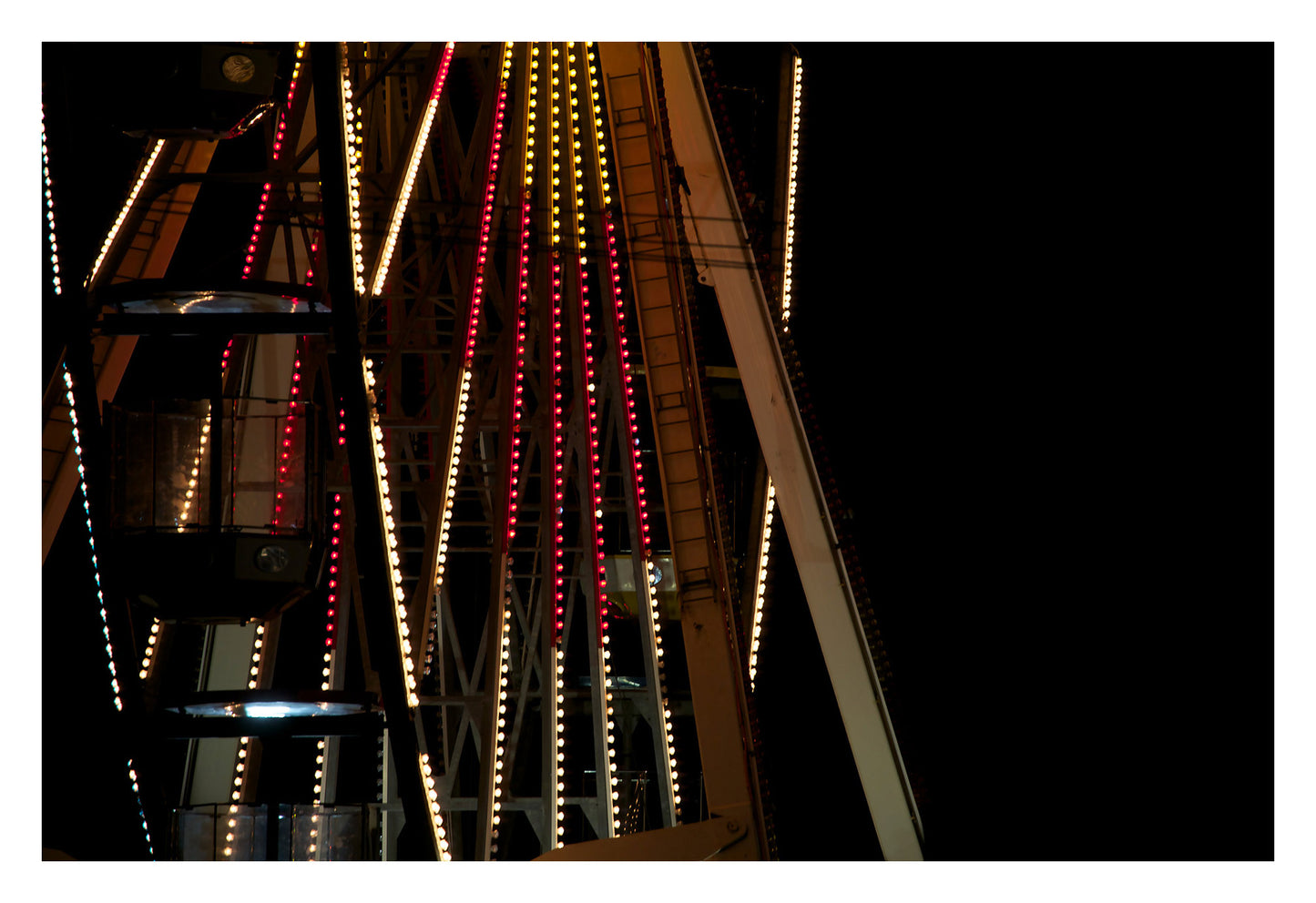 Fairground Carnival Lights 6900075v2 90x60cm - 104x74cm, dramatic close-up of Ferris wheel structure with vibrant cables and night carnival scene, fine art limited edition print by Raymond Mather, ART1.