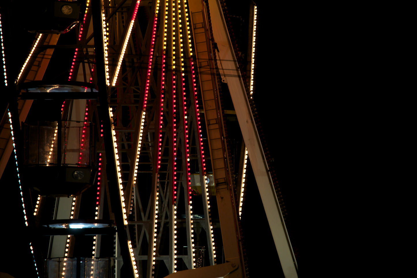 Fairground Carnival Lights 6900075v2 90x60cm - 90x60cm, dramatic close-up of Ferris wheel structure with vibrant cables and night carnival scene, fine art limited edition print by Raymond Mather, ART1.