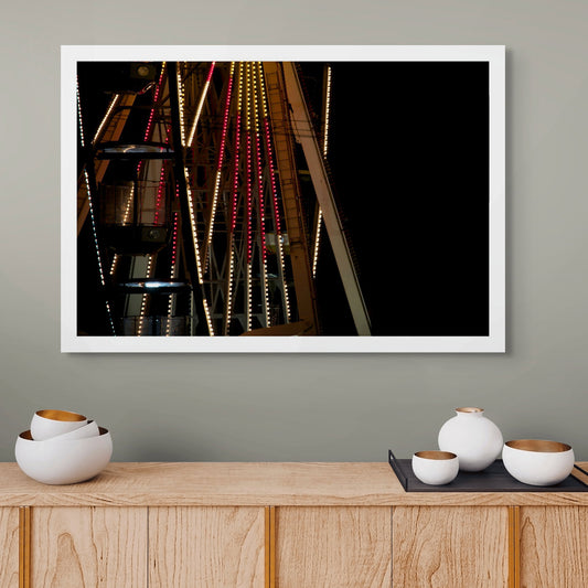 Fairground Carnival Lights 6900075v2 90x60cm - Room View, dramatic close-up of Ferris wheel structure with vibrant cables and night carnival scene, fine art limited edition print by Raymond Mather, ART1.