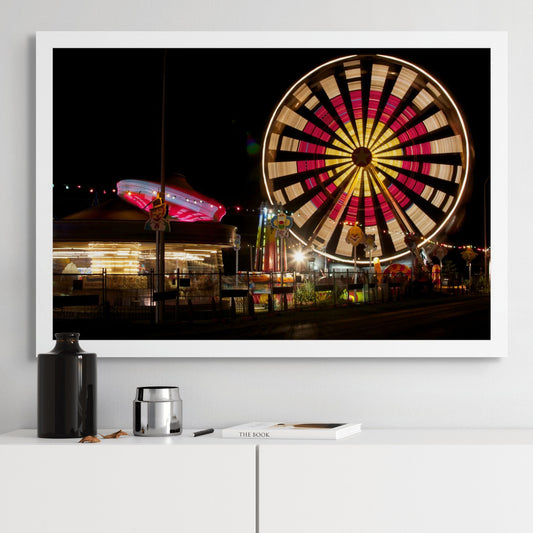 Fairground Carnival Lights 6900102 - Room View, illuminated Ferris wheel and carnival rides at night with vivid red and yellow lights, fine art limited edition print by Raymond Mather, ART1.