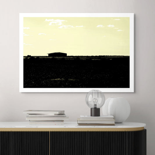 Vivid Country - Hay Plains Shed - 4945v17 - Room View, a silhouetted shed on the vast Australian Hay Plains under a pale yellow sky, evoking stillness, space, and minimalist rural beauty.