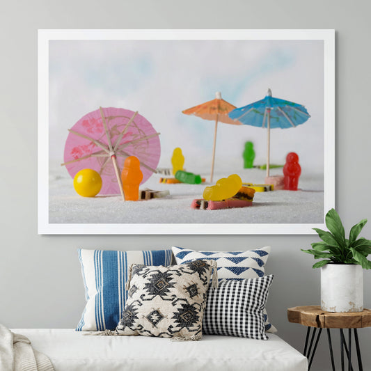Life’s a Beach 1395 - Room View, colourful jelly baby figures staged on a sugar-sand beach with cocktail umbrellas, licorice towels, and a yellow beach ball, fine art still life by Raymond Mather, ART1.