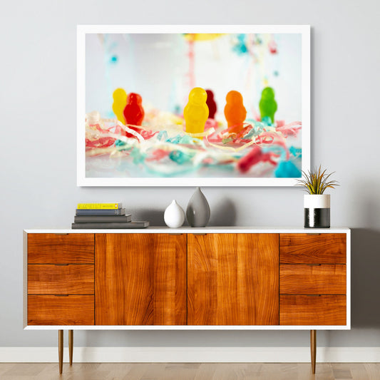Life’s a Party 2417v2 - Room View, colourful jelly baby figures surrounded by festive paper streamers on a reflective white surface, fine art photograph by Raymond Mather, ART1.