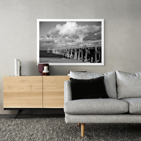 Monochrome Mix - Jetty - Coffs Harbour - 186500v1 - Room View, A black and white photograph of the Coffs Harbour jetty under a sky of dramatic clouds, with strong structural contrast and sweeping perspective. Limited edition fine art print.