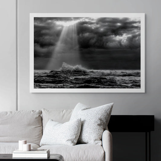 Monochrome Mix - Valla Beach - Cloud Burst - 171683 - Room View, Black and white photograph of stormy ocean waves crashing on rocks beneath dramatic cloud cover, with beams of sunlight piercing through the clouds over Valla Beach.