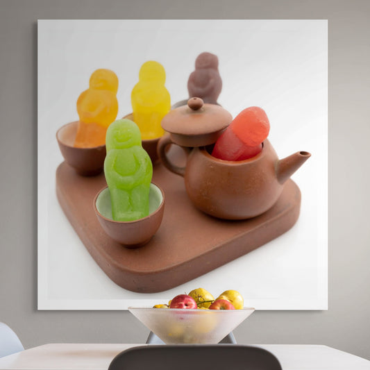 Not My Cup of Tea 3013v2 - Room View, conceptual fine art photograph by Raymond Mather featuring brightly coloured jelly baby figures arranged within a miniature clay tea set, playfully subverting the familiar idiom in a scene of joyful visual whimsy.