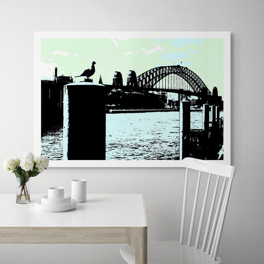 POPscape Sydney - Circular Quay - Seagull - Harbour Bridge - 19044v53a - Room View, Stylised artwork of a seagull perched on a harbour post in the foreground, with Sydney Harbour Bridge silhouetted in the background against a soft pastel green and blue sky.