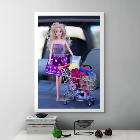 Trolley Dolly - Series No.1: 197392 - Room View, a blonde fashion doll in a purple dress stands beside a miniature trolley filled with fabric, clips, beads, and essentials, photographed inside a car. The image explores hidden homelessness and the feminine burden of appearing composed amid survival.