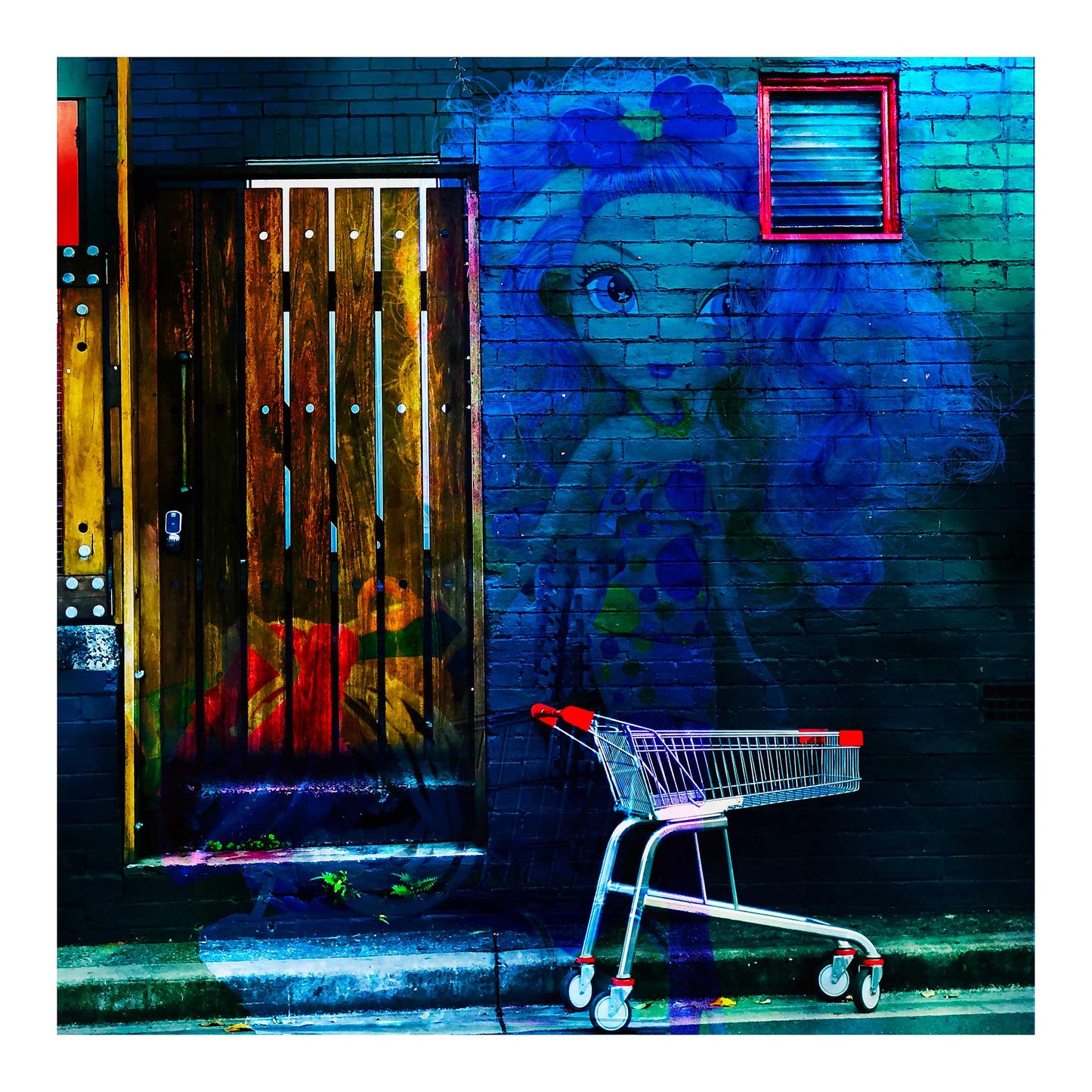 Trolley Dolly - Series No.2: 19E2255v10 - Close Detail View, a translucent doll with long curly hair and a polka dotted dress is layered over a dark brick wall. A red handled shopping trolley sits nearby on the curb, and a timber door to the left glows with textures of fruit and fabric. The image evokes social invisibility and homelessness through a vibrant, symbolic composition.