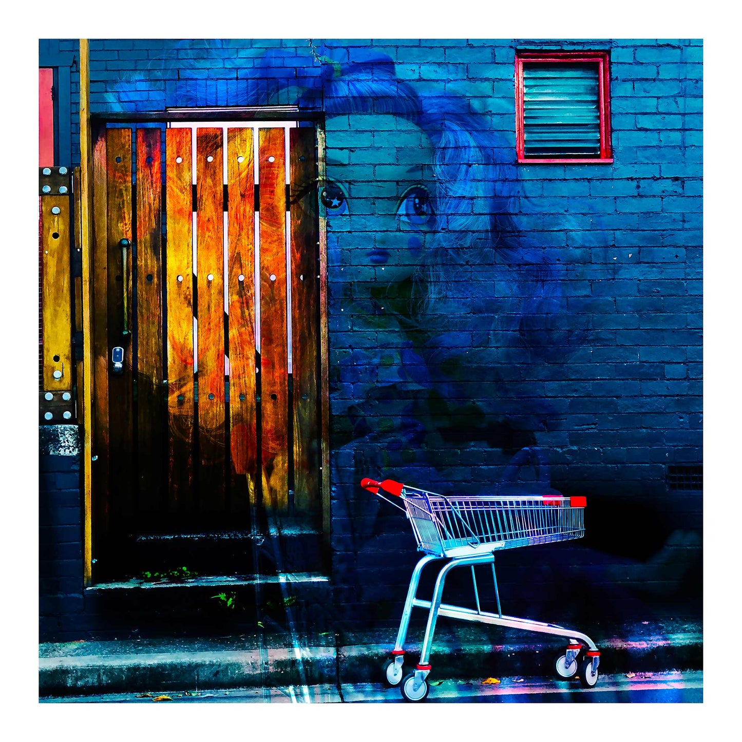 Trolley Dolly - Series No.2: 19E2255v7 - 74x74cm, a ghostly doll with large eyes emerges from a dark blue brick wall beside a red handled shopping trolley. A timber door glows with fiery textures layered from market imagery. The surreal scene explores invisibility, homelessness, and emotional fragility through layered urban symbolism.