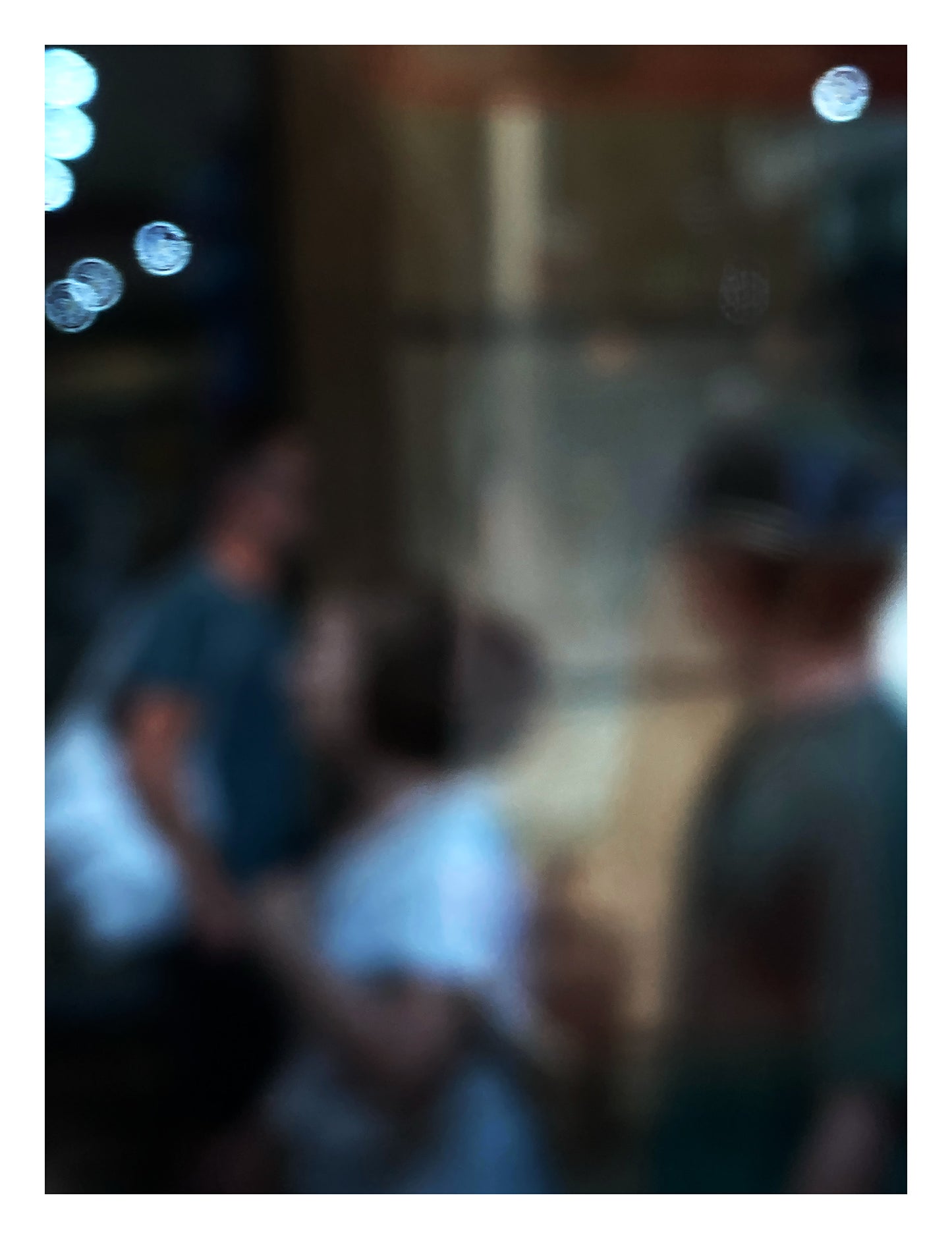 Urban Commute - Series No.1: 0959v1 - 81.5x104cm, a soft focus photograph of three indistinct commuters passing in golden light, with glowing bokeh orbs to the left. Evokes the quiet rhythm and abstraction of morning city life in motion. Photography by Raymond Mather. Limited edition fine art print.