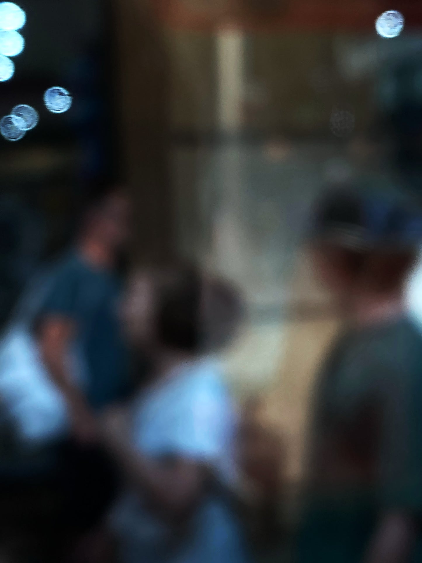 Urban Commute - Series No.1: 0959v1 - 67.5x90cm, a soft focus photograph of three indistinct commuters passing in golden light, with glowing bokeh orbs to the left. Evokes the quiet rhythm and abstraction of morning city life in motion. Photography by Raymond Mather. Limited edition fine art print.
