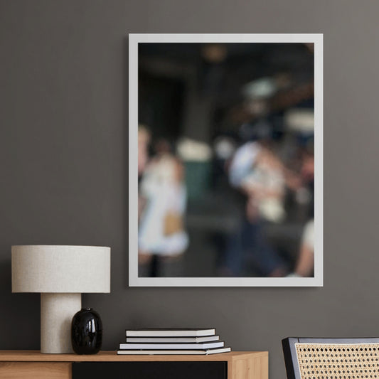 Urban Commute - Series No.1: 0977v1 - Room View, a soft focus image of commuters standing and conversing near an entrance or station facade. Blurred outlines suggest movement and pause, with light brushing softly across their forms. A moment of urban rhythm and intimacy. Limited edition fine art print by Raymond Mather.