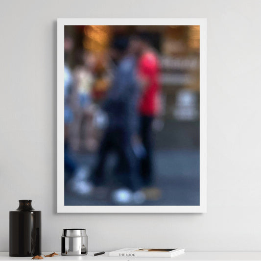 Urban Commute - Series No.1: 0983v1 - Room View, a soft focus photograph of blurred pedestrians in motion, with one figure in bright red passing a golden-lit city storefront. A painterly exploration of rhythm, anonymity, and colour in the urban commute. Limited edition fine art print by Raymond Mather.