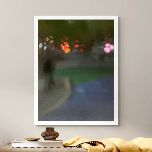 Urban Commute - Series No.1: 1209v1 - Room View, a soft focus night scene featuring a solitary walker in a darkened streetscape. Vibrant bokeh lights in red, amber, and pink hover in the distance, surrounded by deep shadow and soft city tones. Limited edition fine art print by Raymond Mather.