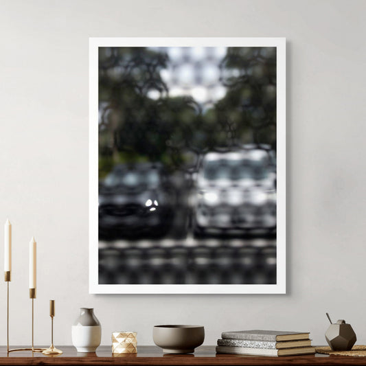 Urban Commute - Series No.2: 8468(1)v1 - Room View, fine art photograph by Raymond Mather featuring a soft-focus image of two parked cars, one dark, one white, viewed through a textured, patterned screen. The effect blurs details and creates a moody, abstract urban vignette rich in contrast and stillness.