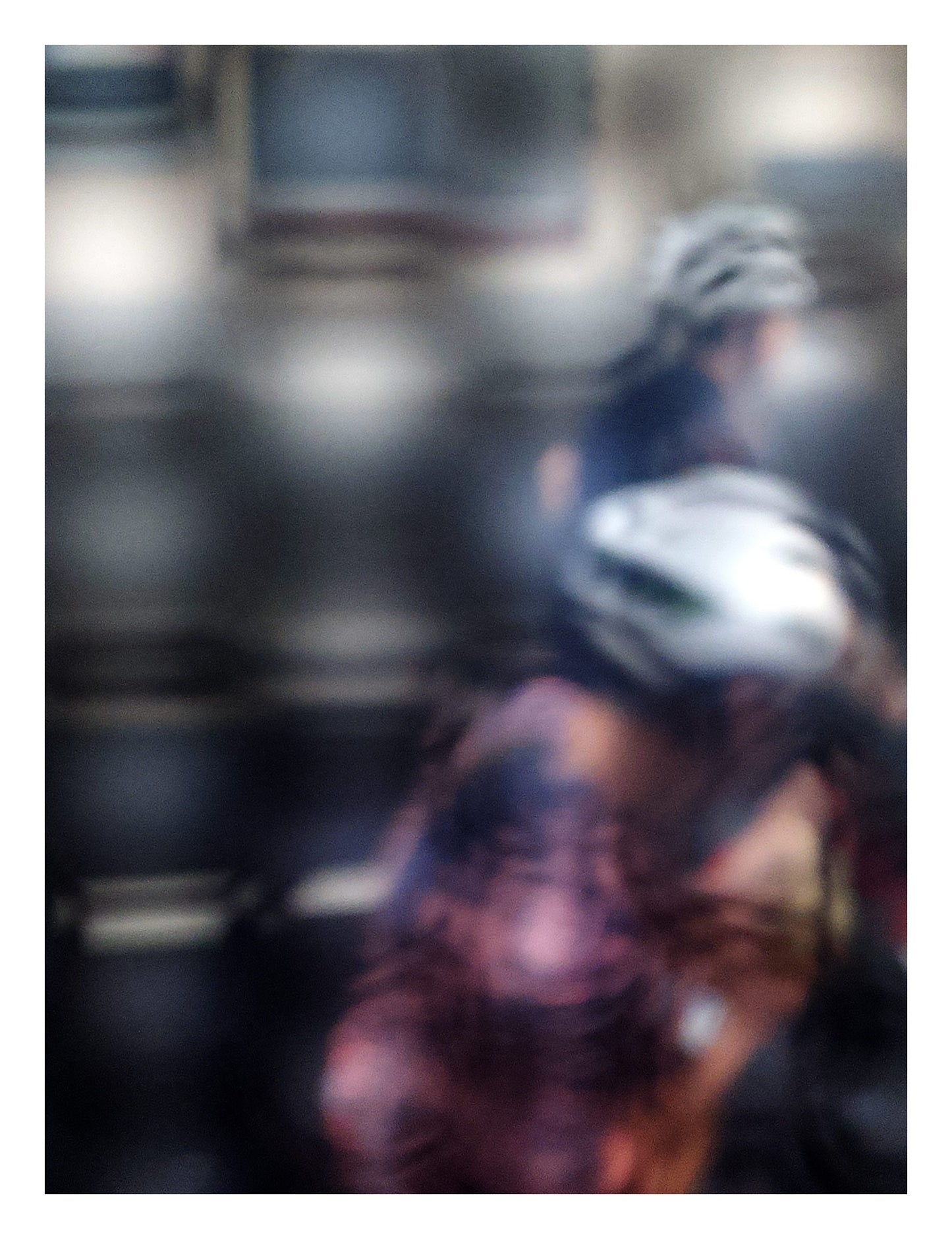 Urban Commute - Series No.2: 8622(1) - 81.5x104cm, fine art photograph by Raymond Mather featuring two blurred cyclists in motion, seen through a diffused surface. The image blends pink, navy, and silver tones into an abstract composition of rhythm, reflection, and fleeting urban energy.