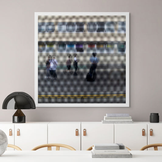 Urban Commute - Series No.2: 9557(1)v1a - Room View, fine art photograph by Raymond Mather showing a group of pedestrians viewed through a circular patterned screen, with a colourful row of panels or bins behind them. The scene is abstracted into a rhythmic visual composition.