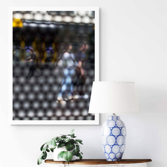 Urban Commute - Series No.2: 9611 - Room View, abstract city street scene with two blurred figures walking side by side through a honeycomb patterned filter, with warm ambient light, soft shadows, and diffuse reflections suggesting early morning movement, limited edition fine art print by Raymond Mather, ART1.