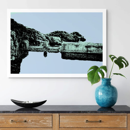 Vivid Country - Sawtell Rockpool - 7527v7 - Room View, a minimalist Pop Art-style print of a weathered ocean rockpool surrounded by coastal rock formations, shown in soft pastel tones of blue and green. A still, contemplative coastal scene.