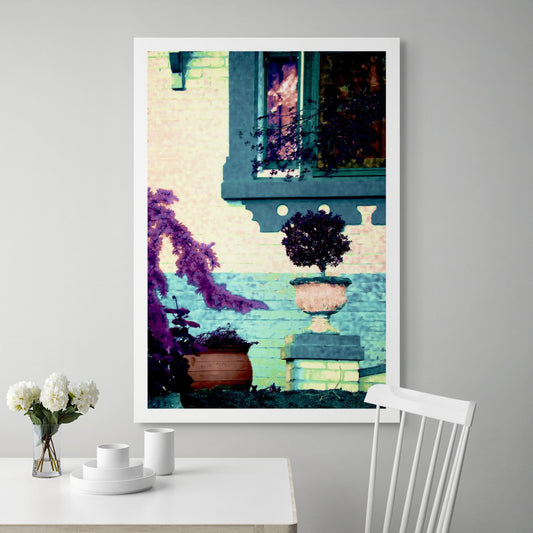 Vivid Country - Tamworth Garden Pot Plant - 4819-2v20a - Room View, a stylised garden scene showing a potted topiary in a classical urn, framed by lavender-toned foliage and a turquoise brick wall. A window reflects soft light, adding warmth and subtle narrative to the Pop Art-style image.