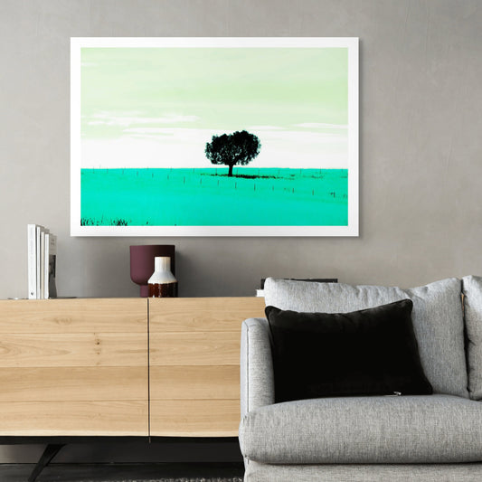 Vivid Country - Tamworth Moore Creek - 2853v209a - Room View, a lone tree stands in a vast green field under a pale mint sky, framed by evenly spaced fence posts. A minimalist Pop Art style landscape evoking stillness, solitude, and connection to place.