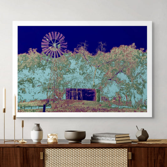 Vivid Country - Tamworth Windmill - 4739v10 - Room View, a tall metal windmill stands beside a large tank under stylised eucalyptus trees, set against a bold Pop Art sky of navy and pastel blue. Earthy purples and greens evoke a transformed rural landscape full of mood and memory.
