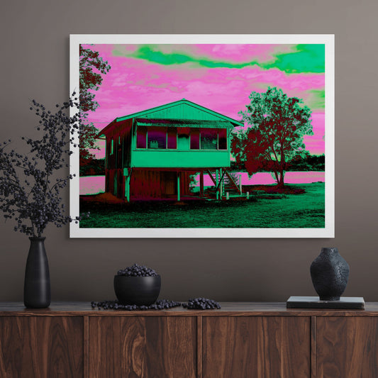 Vivid Country - Urunga River House - 6394v24a - Room View, a Pop Art style fine art print depicting a raised weatherboard house beside the river in Urunga, NSW. Rendered in vibrant green and pink tones with rich shadowing, the image celebrates everyday architecture and riverside stillness.