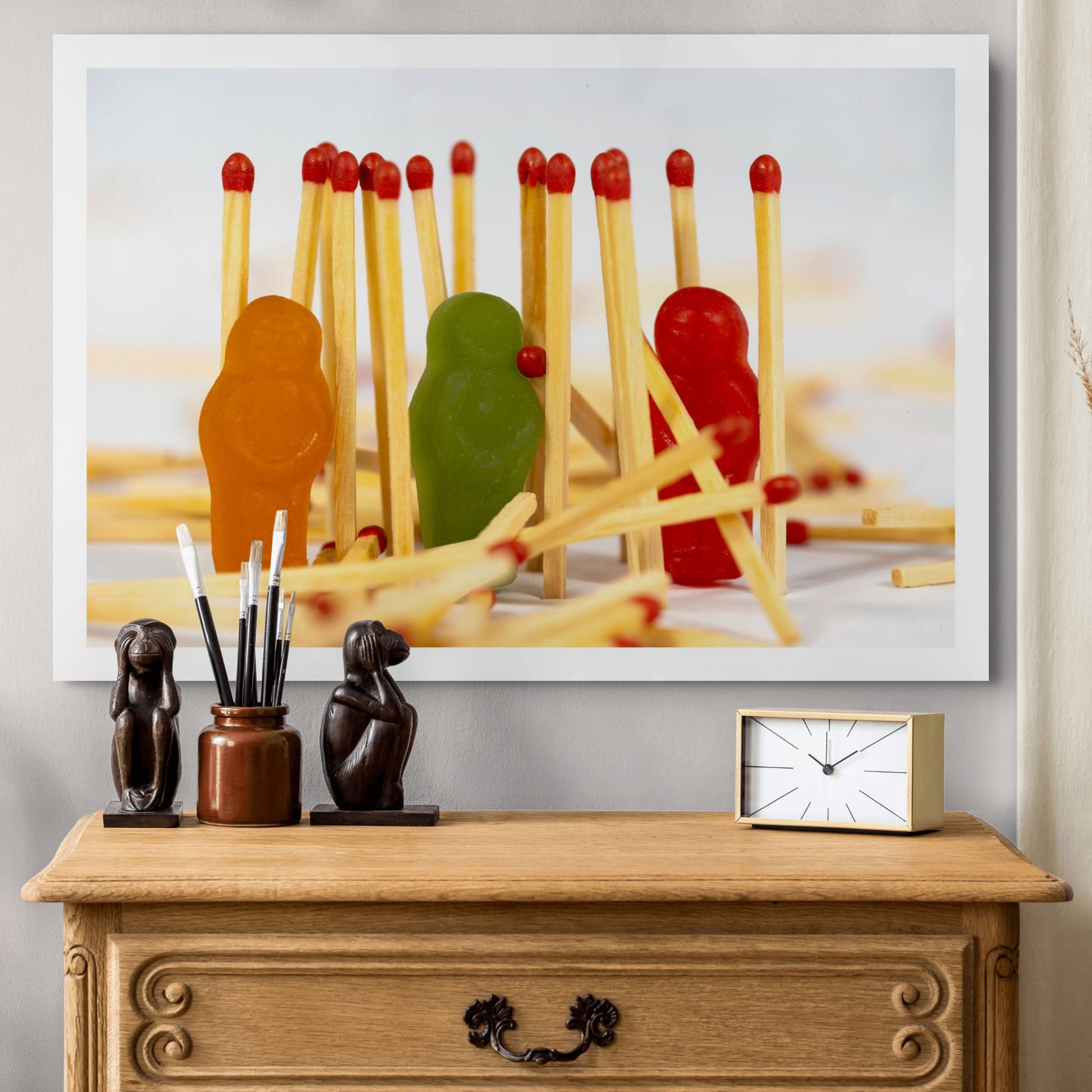 Baby Light My Fire photographic artwork displayed as a large white-framed print above a timber cabinet in a contemporary interior.