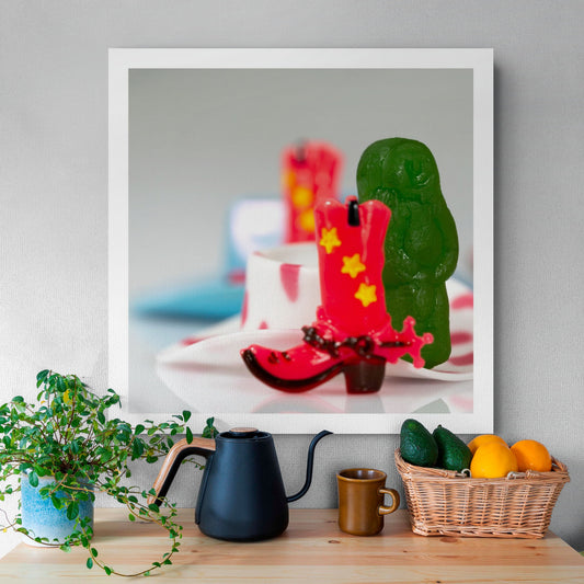 Boot Scootin’ Baby 266835v1 by Raymond Mather displayed as a square photographic artwork above a timber table with plants, black kettle and fruit basket.