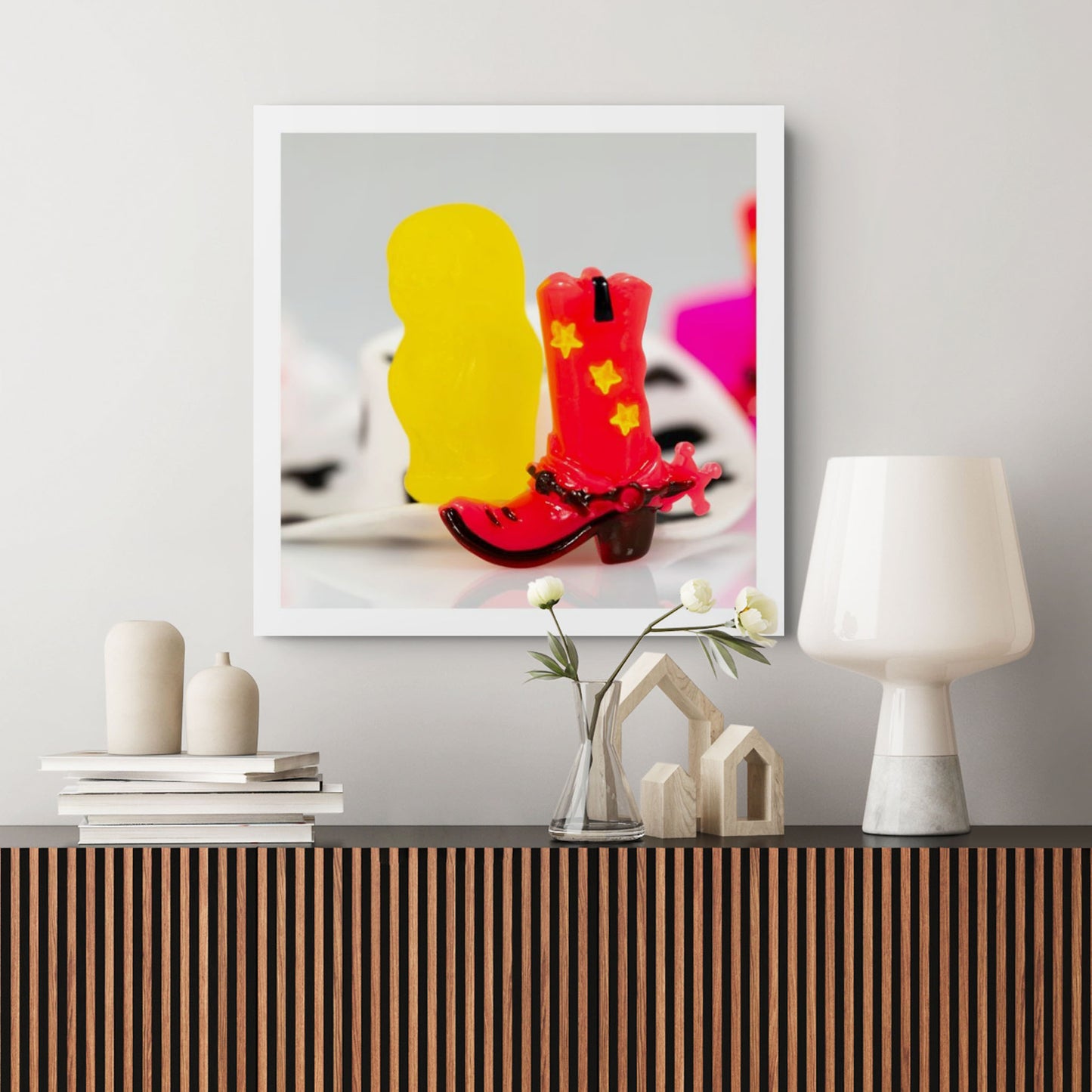Boot Scootin’ Baby 266838v1 by Raymond Mather displayed as a square photographic artwork in a contemporary interior above a timber cabinet with neutral decorative objects.