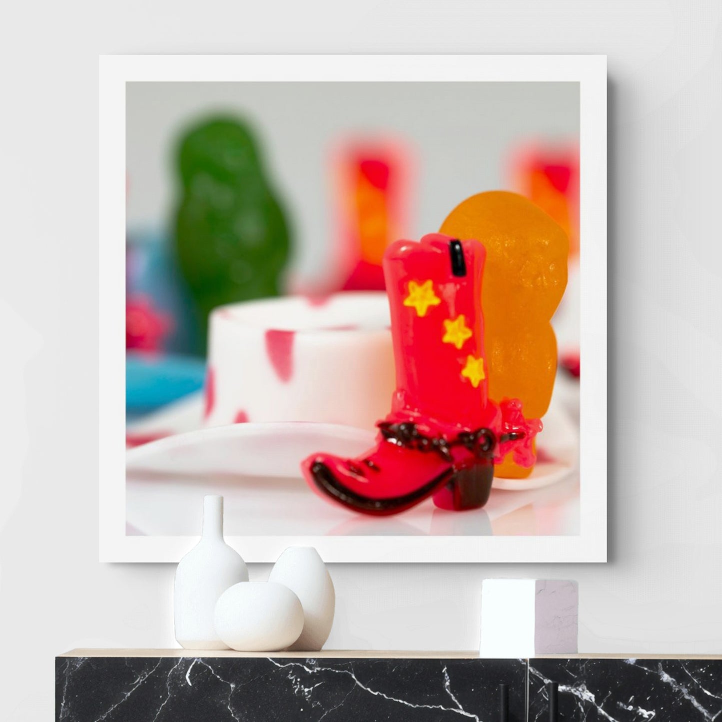 Boot Scootin’ Baby 266846v1 by Raymond Mather displayed as a square photographic artwork above a contemporary black marble console.