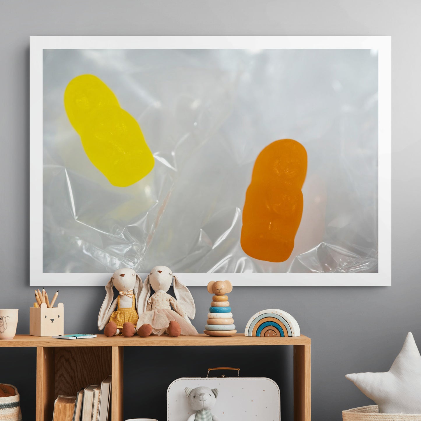 Sleep Like A Baby photographic artwork featuring yellow and orange translucent baby-shaped figures displayed above a timber cabinet in a contemporary interior.