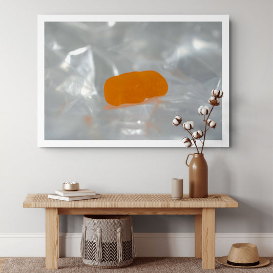 Sleep Like A Baby photographic artwork featuring a translucent orange baby-shaped figure resting within pale reflective folds, displayed in a contemporary interior.