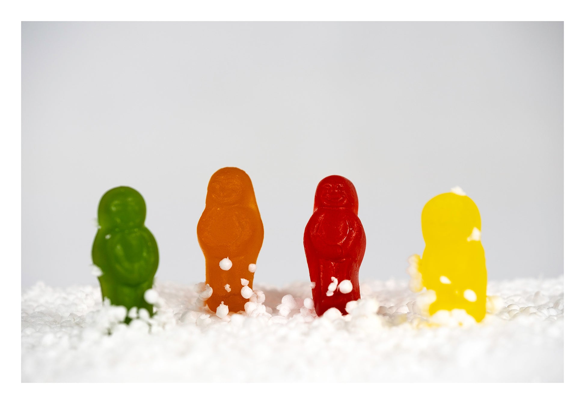 Snow Babes - 267029v1 by Raymond Mather. Four colourful confectionery figures standing in a miniature snow-like landscape.