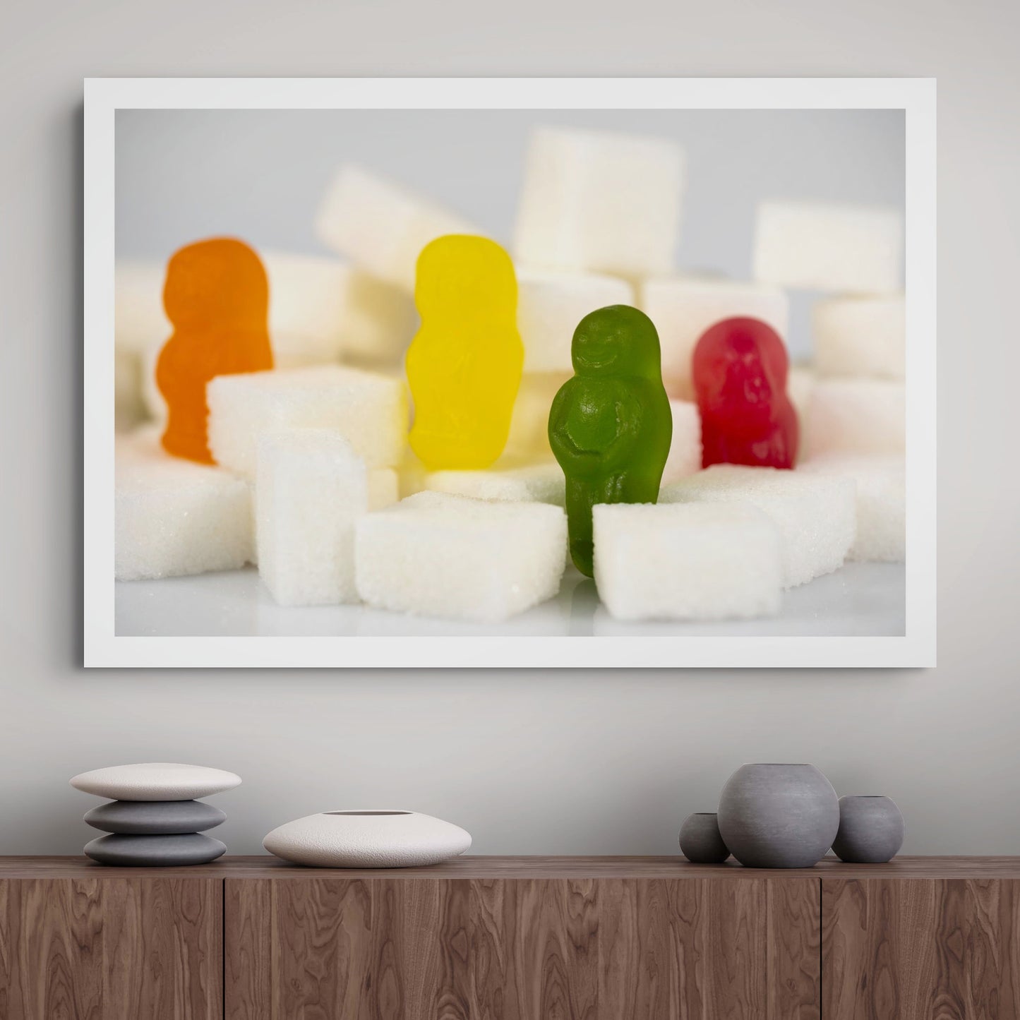 Sugar Babies - 266997v1 framed photographic artwork featuring four colourful confectionery figures standing among white sugar cubes, displayed in a contemporary interior.