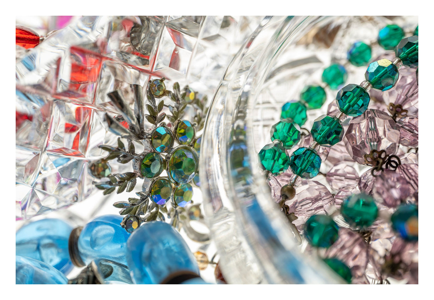 Still Life artwork of blue, green, red, gems and jewels in crystal by Australian photographer Raymond Mather at ART1 Fine Art Photography, with white border allowance view.