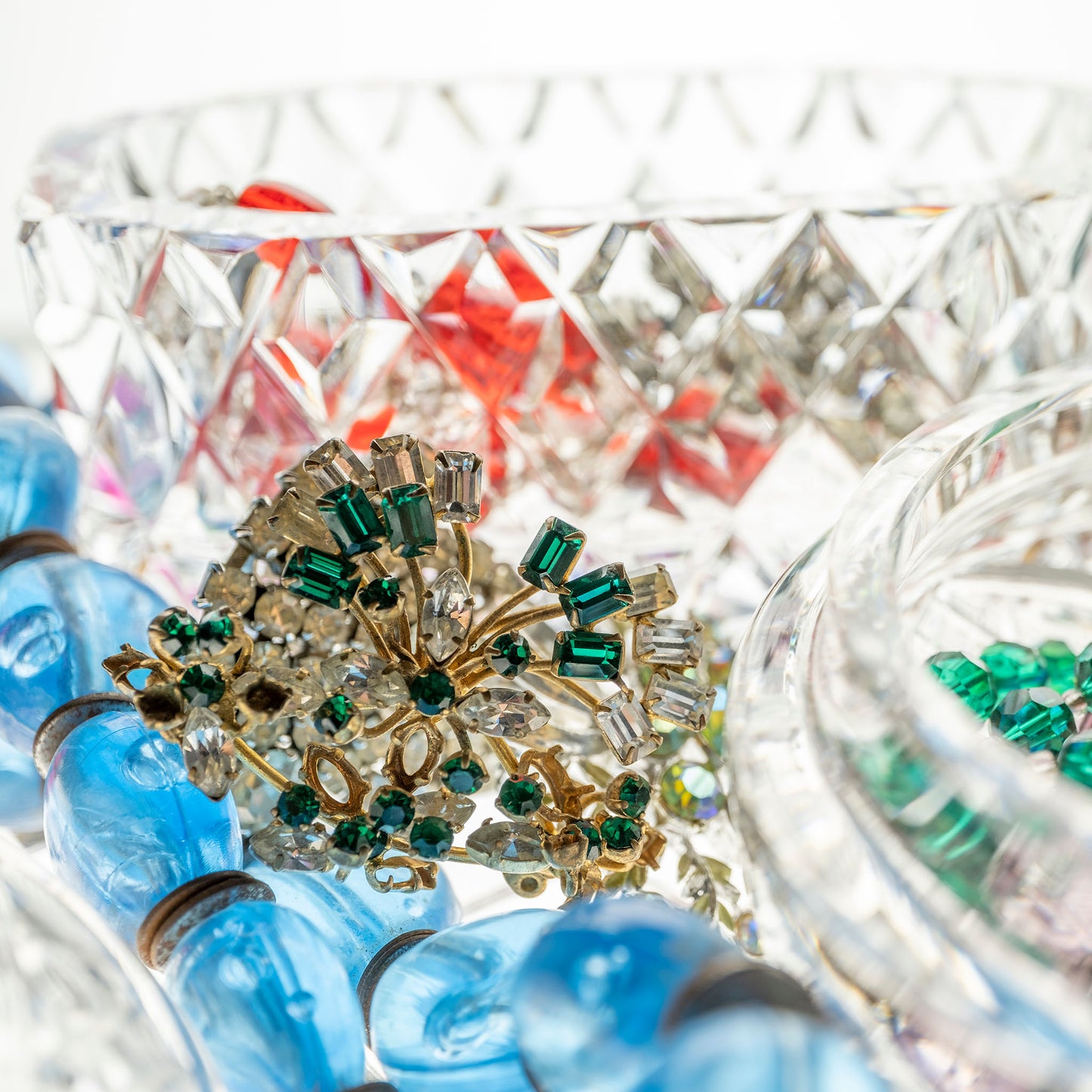 Still Life artwork of blue, green, red, gems and jewels in crystal boxes by Australian photographer Raymond Mather at ART1 Fine Art Photography, detail crop view.