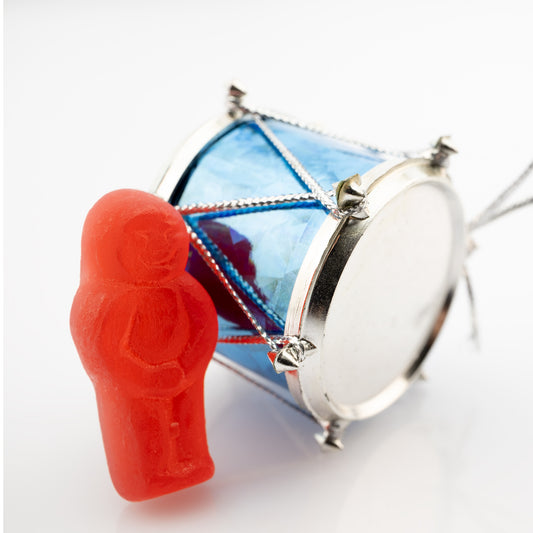 Beat of a Different Drum 2948 - Close Detail View, red jelly figure leaning on a miniature blue drum ornament, fine art photographic print by Raymond Mather, ART1.