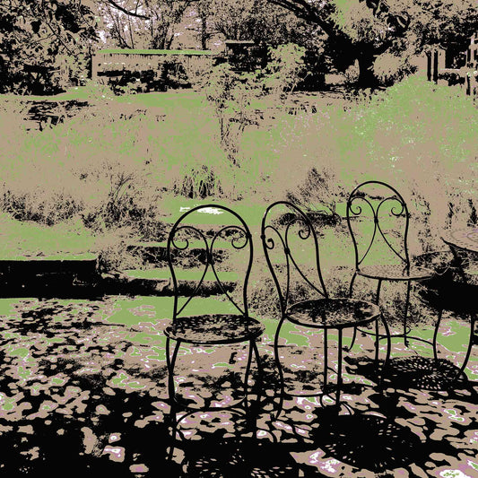 Vivid Country - Castlemaine Buda Garden Seats - 4313v25a - Close Detail View, a trio of vintage wrought iron chairs in dappled shade beneath leafy trees, set against a muted garden backdrop in soft greens and earth tones.