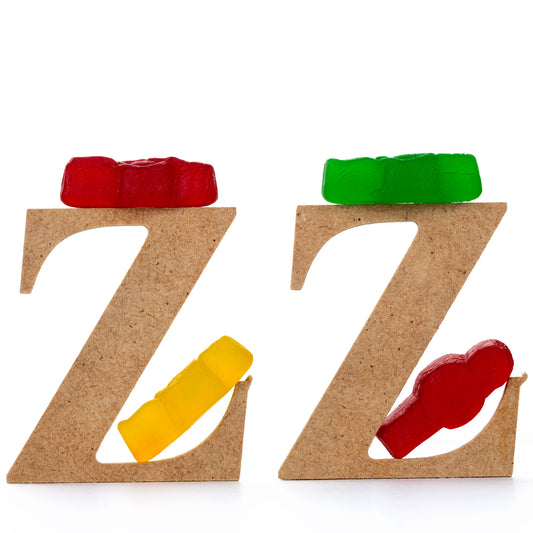 Catching Some ZZZ’s 1501 - Close Detail View, playful fine art photograph featuring three wooden letter Zs each topped with gummy bears and supported by colourful jelly baby figures, part of the Cliché Life series by Raymond Mather, ART1.