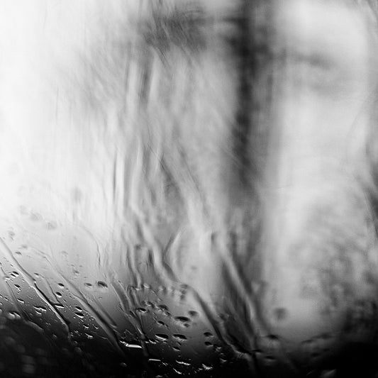 Coastal Noir 7924 - Close Detail View, black and white minimalist coastal photograph with delicate rain droplets on glass creating abstract textures.