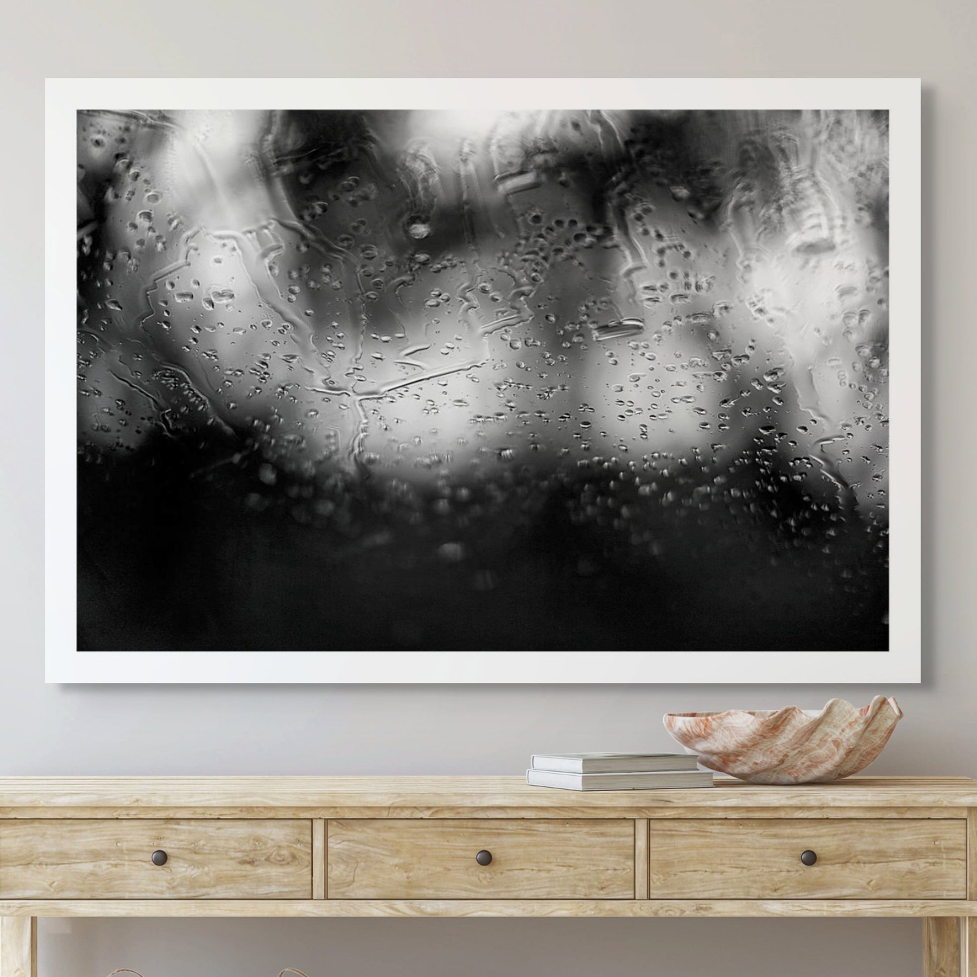 Coastal-Noir 8147 - Room View, black and white coastal photograph with rain-speckled glass creating soft abstract textures over blurred landscape.