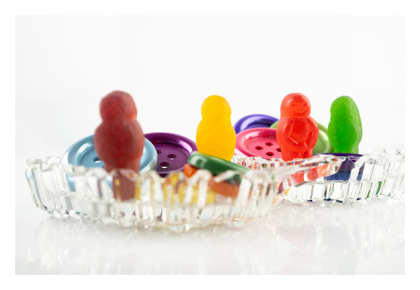 Cute As a Button 2546 - 104x74cm, colourful jelly baby figures posed among large plastic buttons in a vintage-style cut glass dish, fine art photographic print by Raymond Mather, ART1.